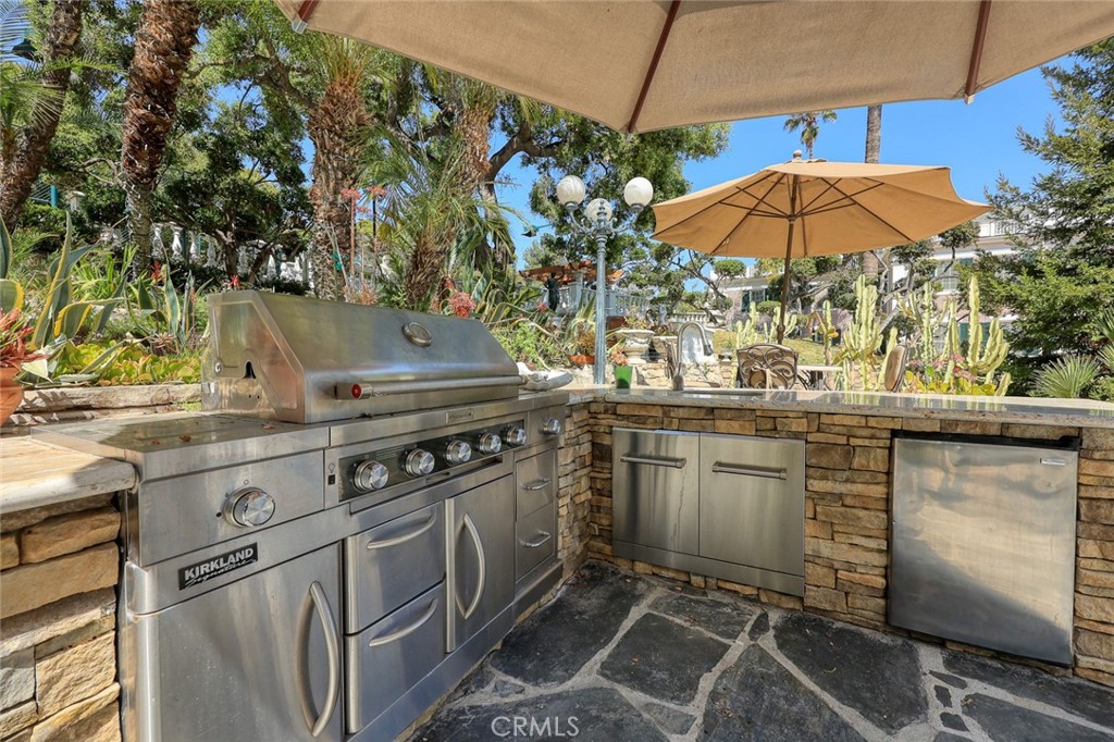 999 Rosalind Road San Marino, CA 91108 - Photo 56 of 70 a kitchen with stainless steel appliances granite countertop a stove a sink and a microwave