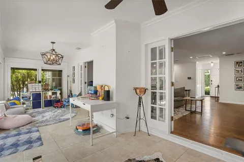 a living room with furniture a table and large windows