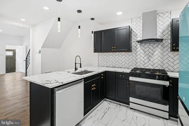 a kitchen with a sink stove and microwave