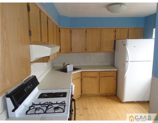 7504 Hana Road Edison, NJ 08817 - Photo 4 of 10 a kitchen with a refrigerator and a stove