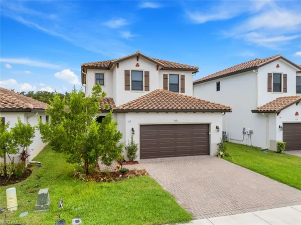 a front view of a house with a yard and garage