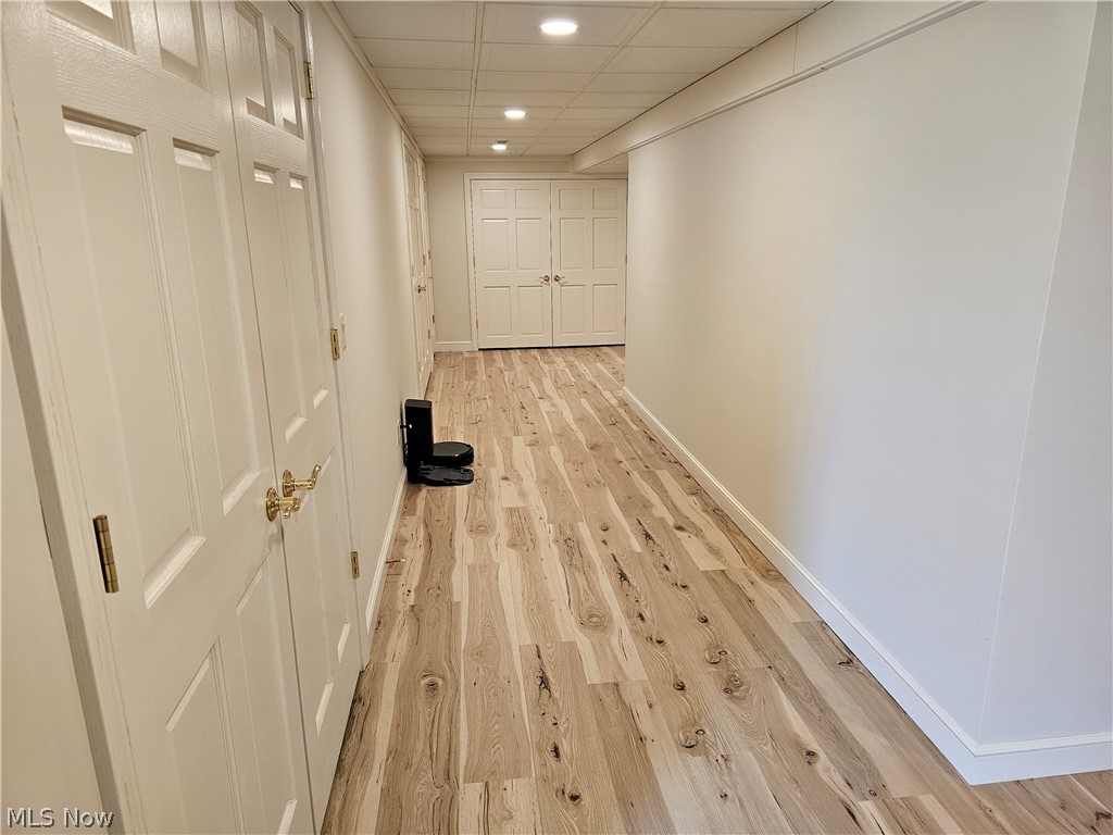 2363 Tabor Ridge Road Northeast New Philadelphia, OH 44663 - Photo 37 of 42 Hallway featuring wood-finish flooring, recessed lighting, white panel doors with brass hardware, and a drop ceiling