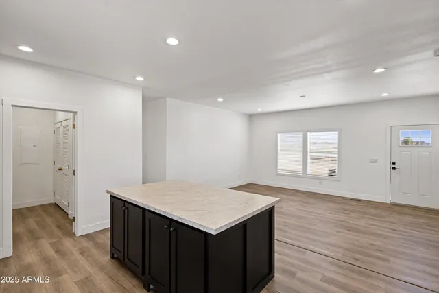 a kitchen with kitchen island a sink appliances and cabinets