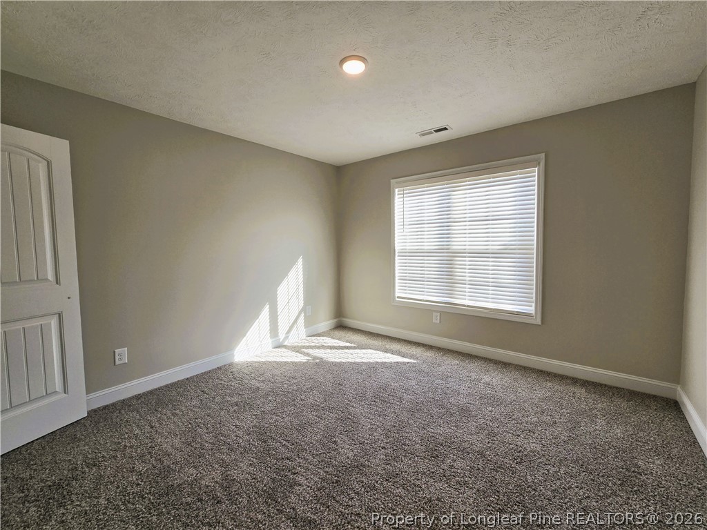 422 Mitchell Farm Road Goldsboro, NC 27530 - Photo 9 of 28 an empty room with windows