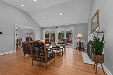 a living room with furniture potted plant and a wooden floor