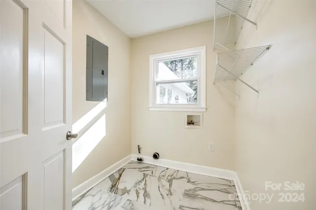 a view of small space with wooden floor and a window