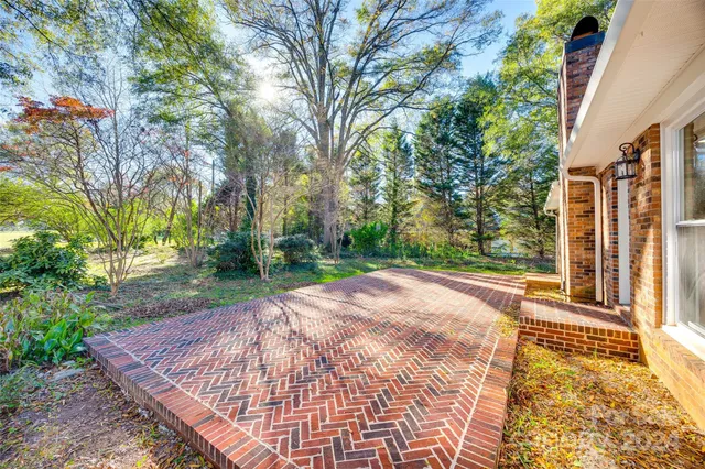 a view of a backyard with table and chairs and wooden fence