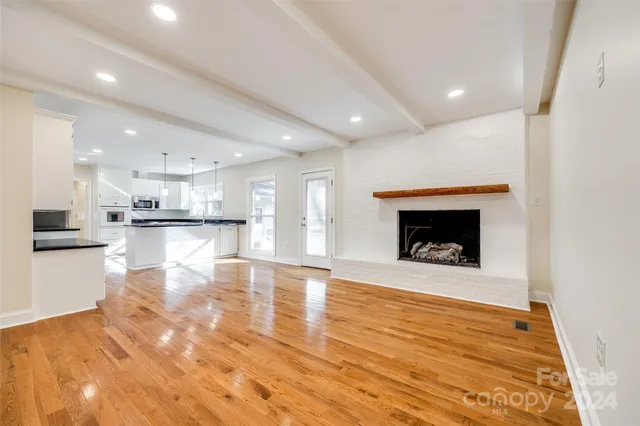 a view of a kitchen with a sink and a fireplace