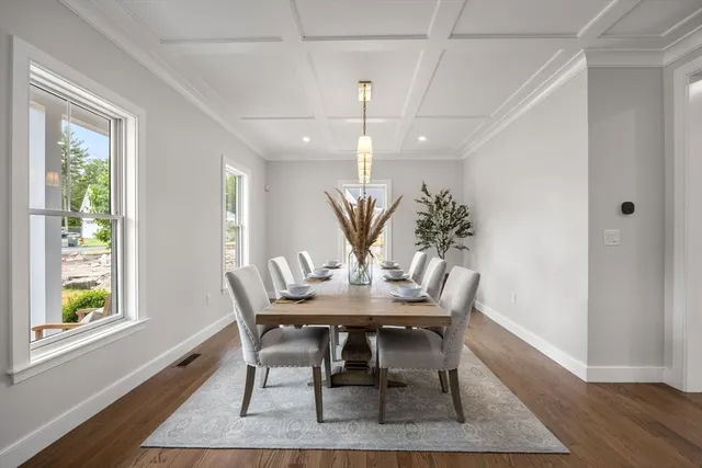 a view of a dining room with furniture and wooden floor