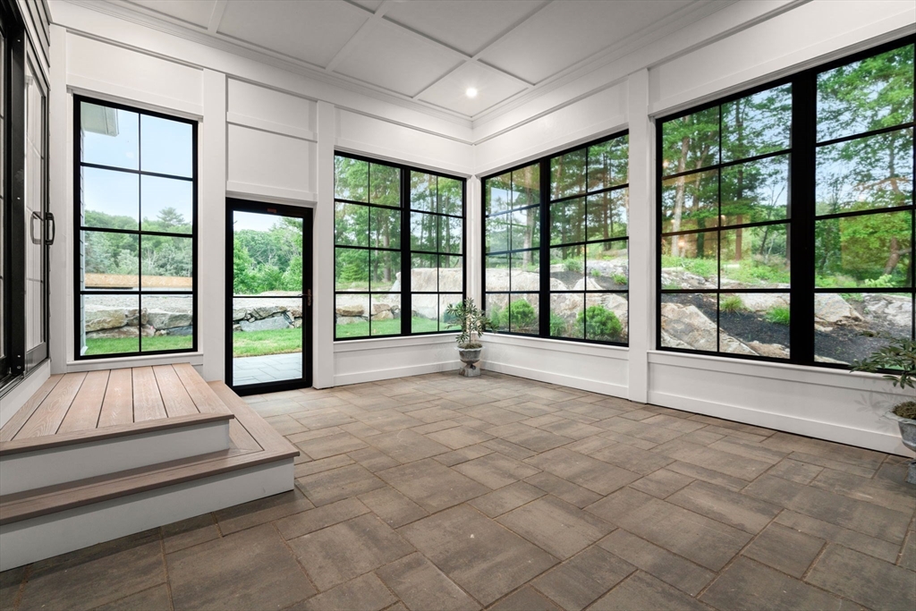 80 Horrigan Drive, Unit 24 Dedham, MA 02026 - Photo 24 of 28 a spacious bedroom with a large window and a balcony