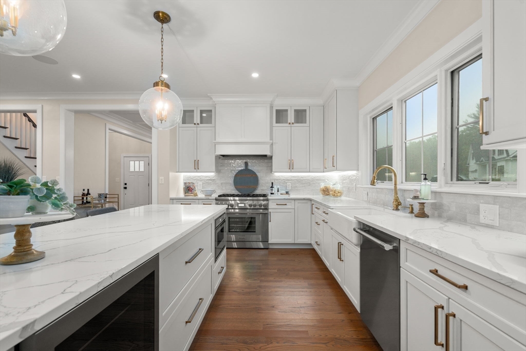 80 Horrigan Drive, Unit 24 Dedham, MA 02026 - Photo 5 of 28 a large kitchen with stainless steel appliances granite countertop a sink stove and cabinets