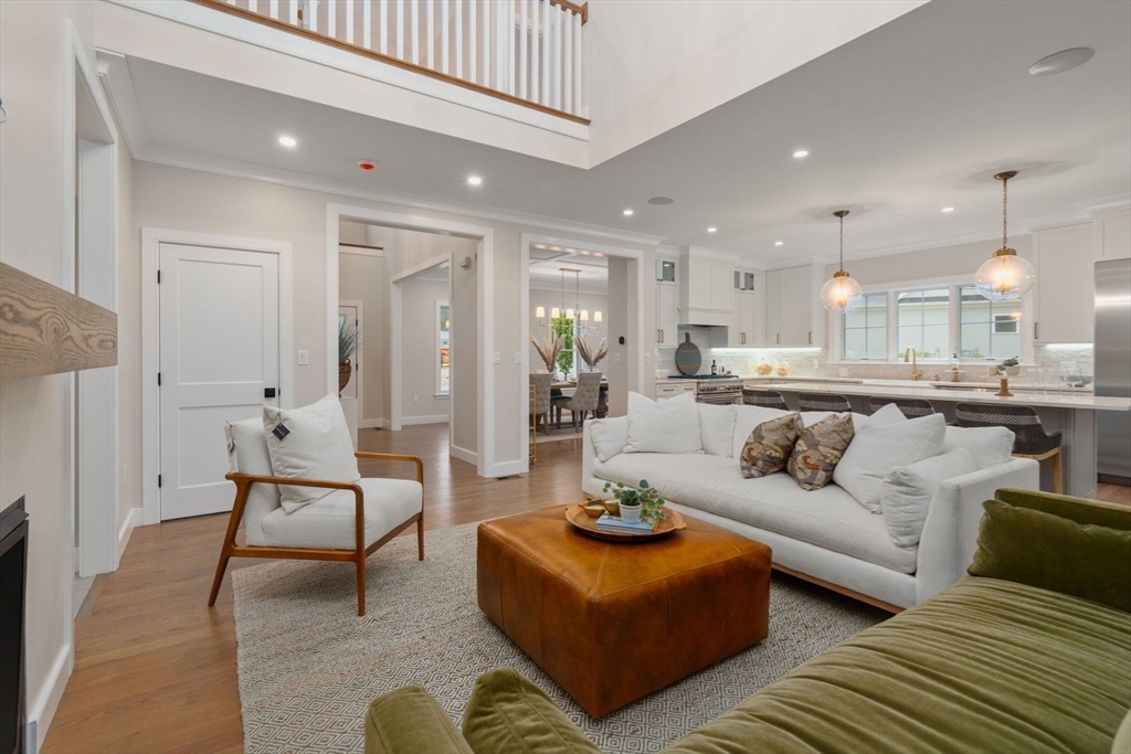 80 Horrigan Drive, Unit 24 Dedham, MA 02026 - Photo 7 of 28 a living room with furniture and a dining table with kitchen view