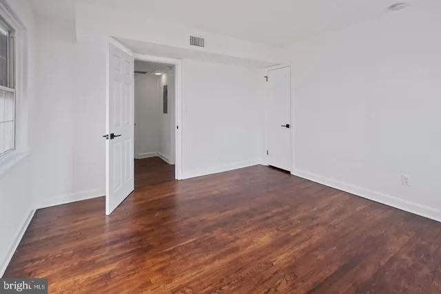 a view of a room with wooden floor