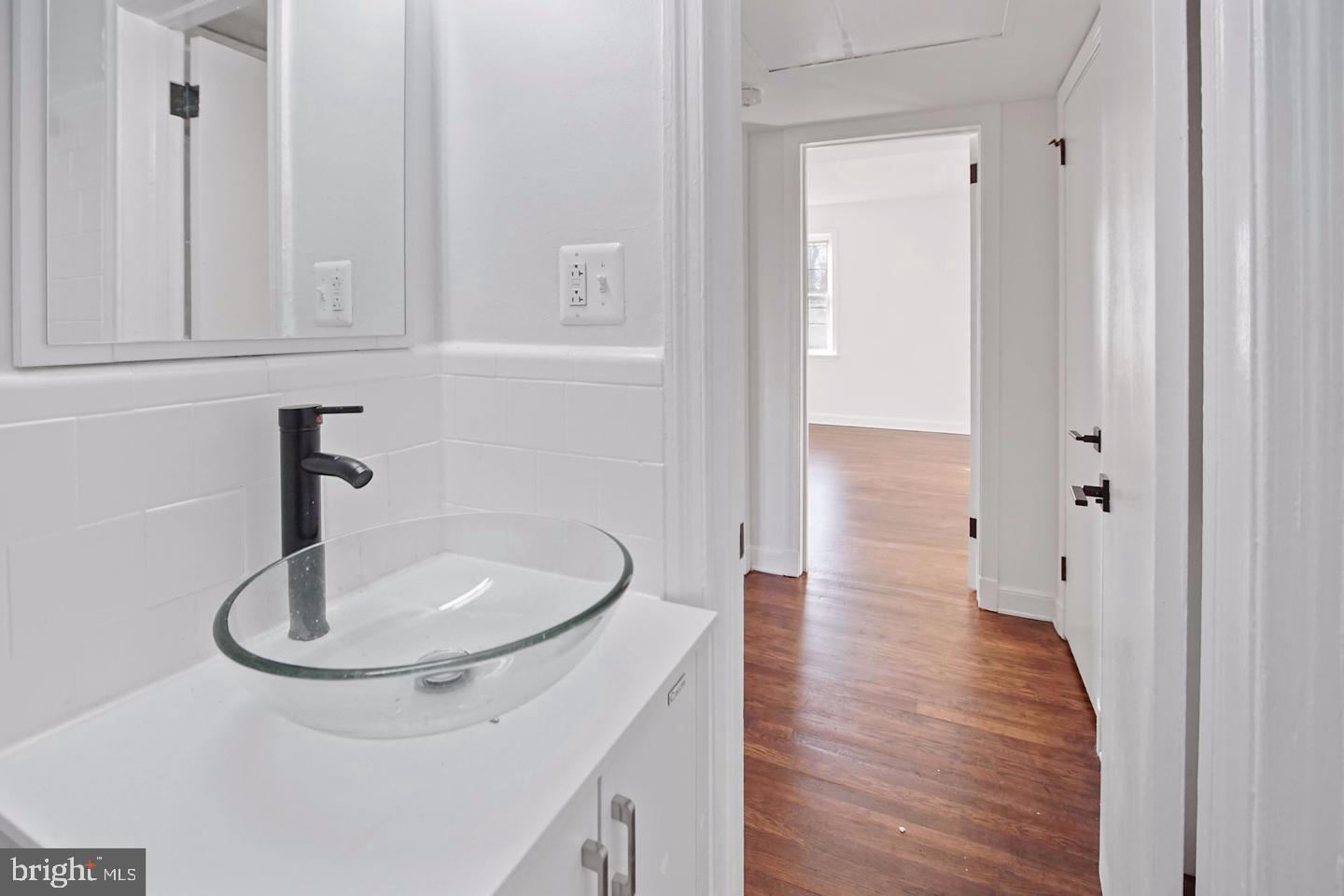 2111 Suitland Terrace Southeast, Unit 302 Washington, DC 20020 - Photo 4 of 11 a bathroom with a sink and a mirror
