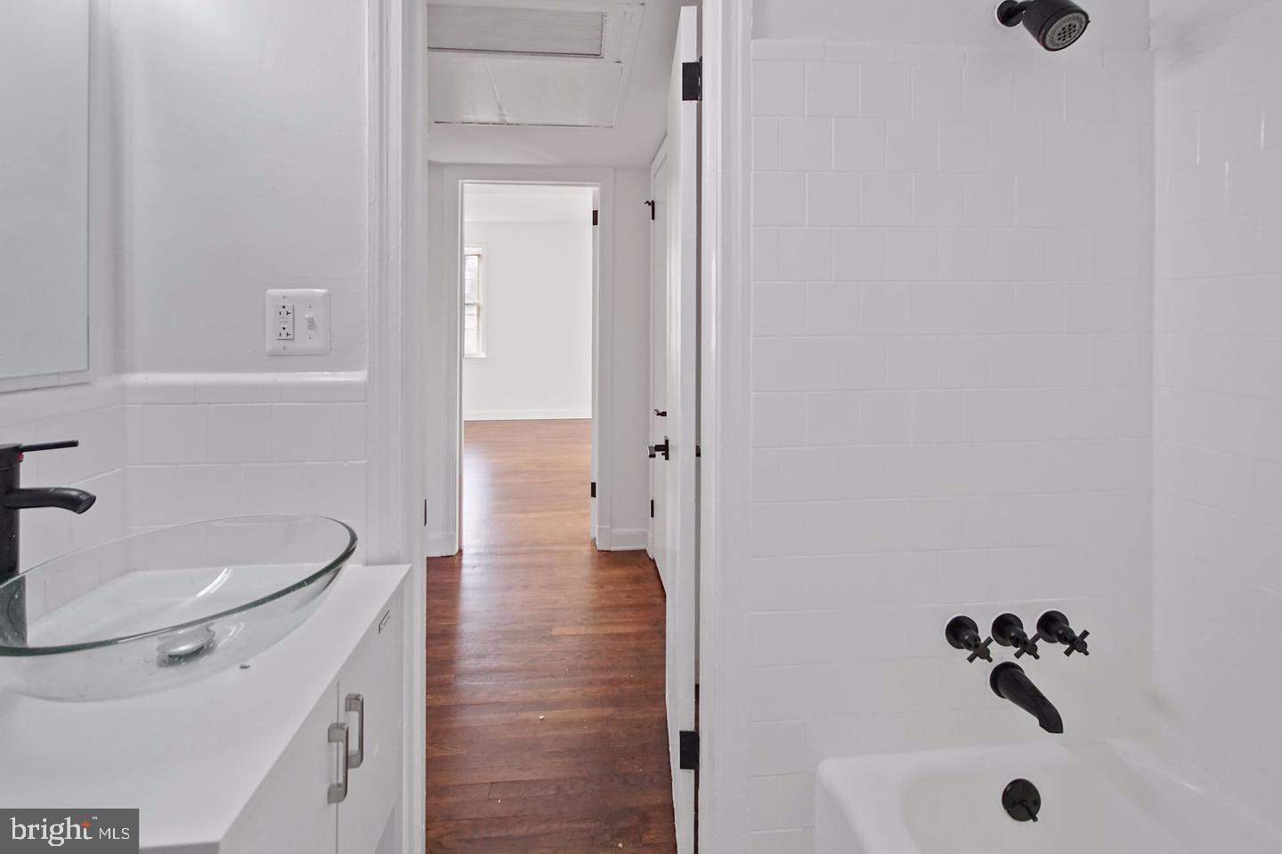 2111 Suitland Terrace Southeast, Unit 302 Washington, DC 20020 - Photo 5 of 11 a bathroom with a sink and a mirror