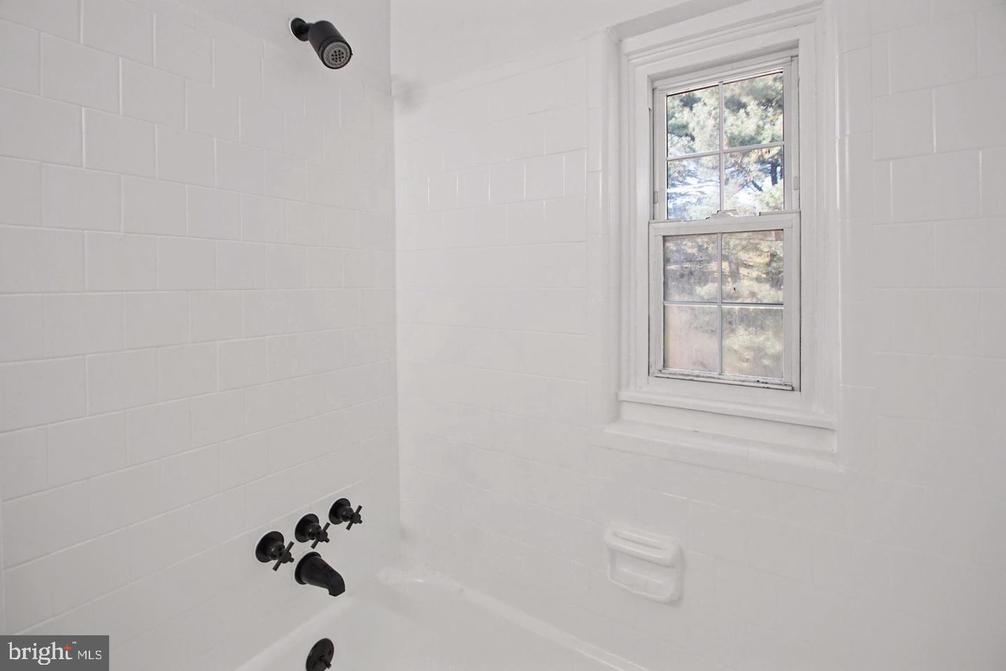 2111 Suitland Terrace Southeast, Unit 302 Washington, DC 20020 - Photo 6 of 11 a bathroom with a bathtub