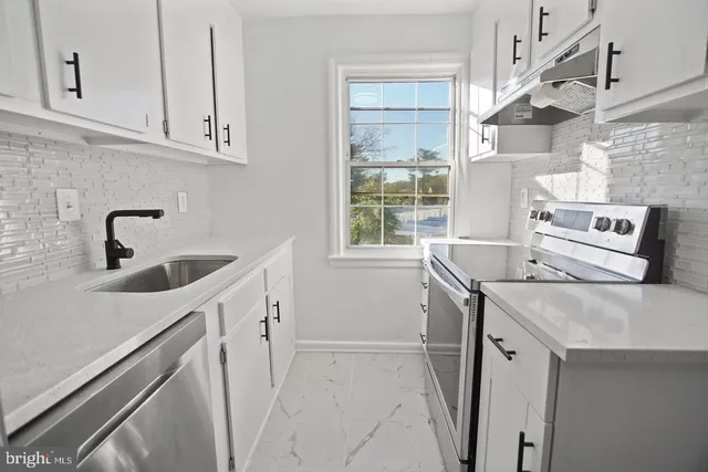a kitchen with a sink stove and refrigerator