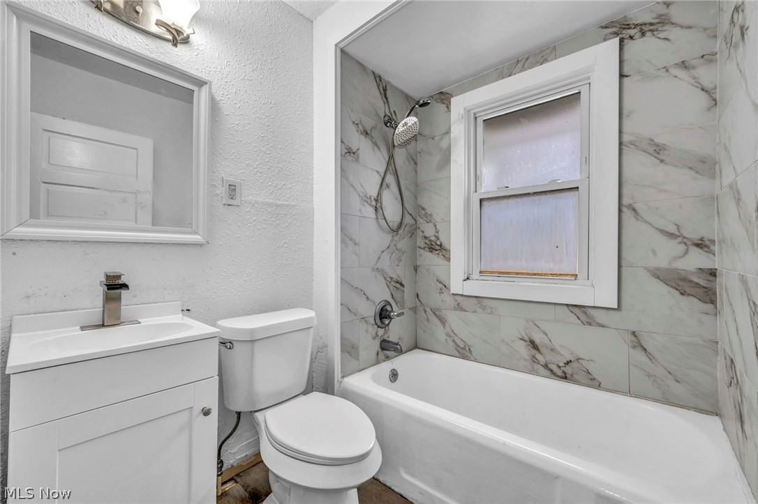 1677 Carlyon Road East Cleveland, OH 44112 - Photo 21 of 41 Bathroom with a textured wall, shower / bath combination, and vanity