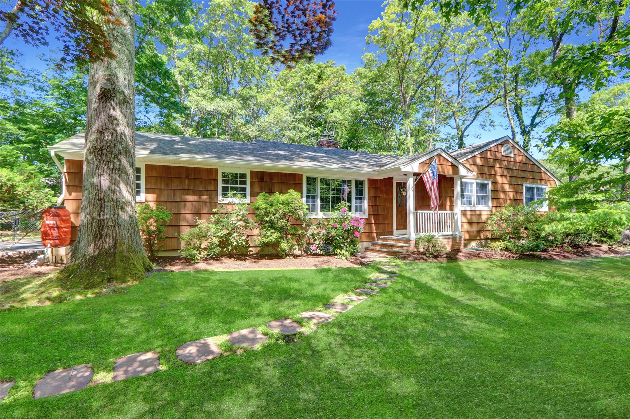 a front view of house with yard and green space