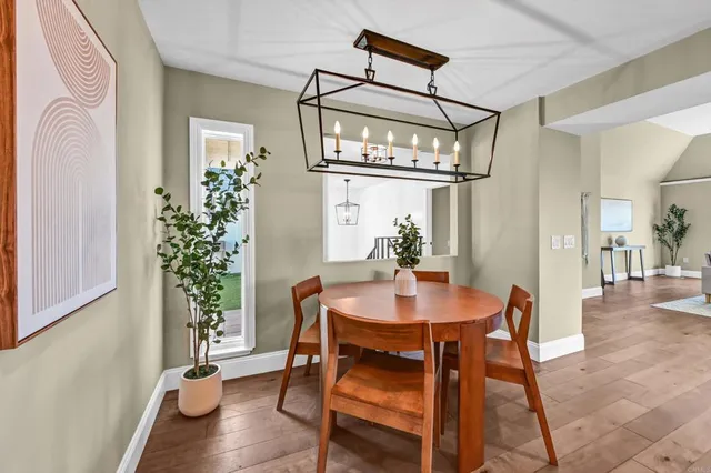 a view of a dining room with furniture and wooden floor