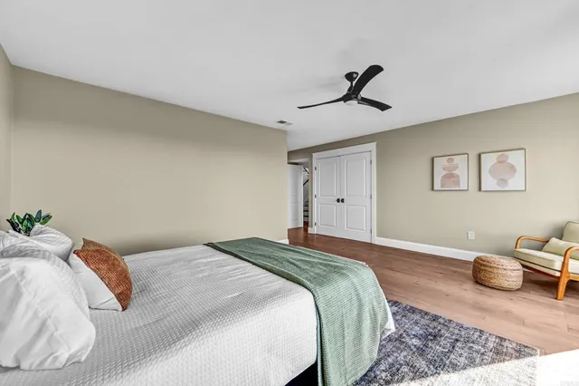 a spacious bathroom with a double vanity sink a large mirror and a shower