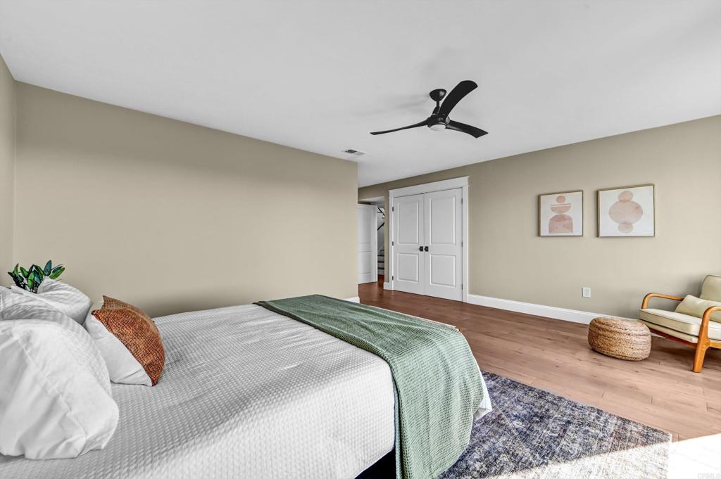 1760 Gascony Road Encinitas, CA 92024 - Photo 19 of 49 a bedroom with a bed and wooden floor