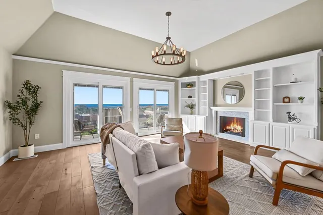 a living room with fireplace furniture and a floor to ceiling window
