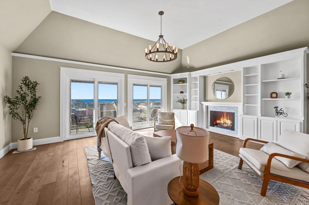 1760 Gascony Road Encinitas, CA 92024 - Photo 2 of 49 a living room with fireplace furniture and a floor to ceiling window