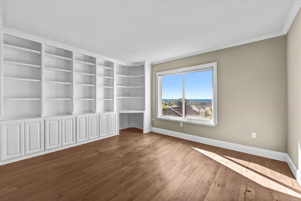 1760 Gascony Road Encinitas, CA 92024 - Photo 26 of 49 a view of an empty room with wooden floor and a window