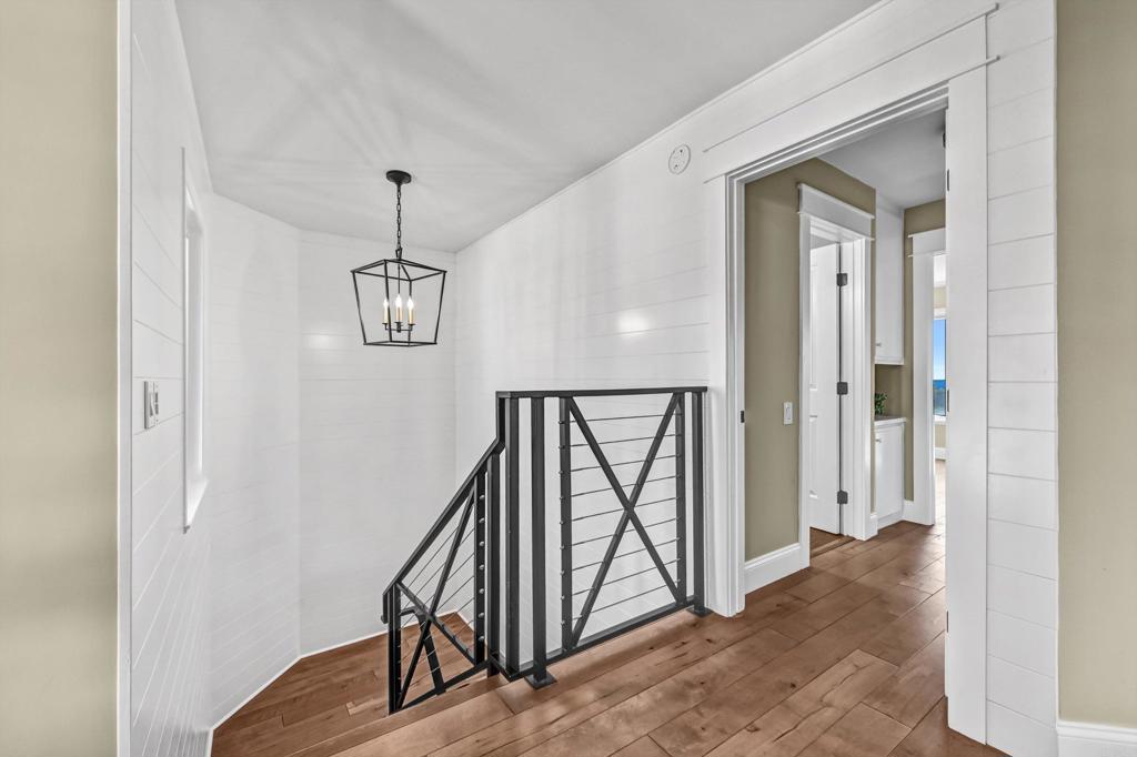 1760 Gascony Road Encinitas, CA 92024 - Photo 28 of 49 a view of a hallway with wooden floor and staircase