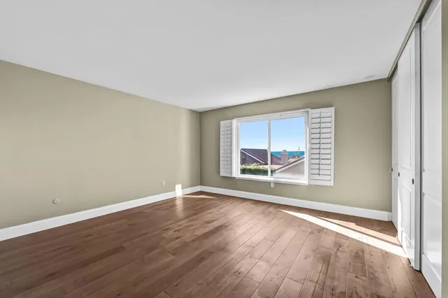 a view of an empty room and wooden floor