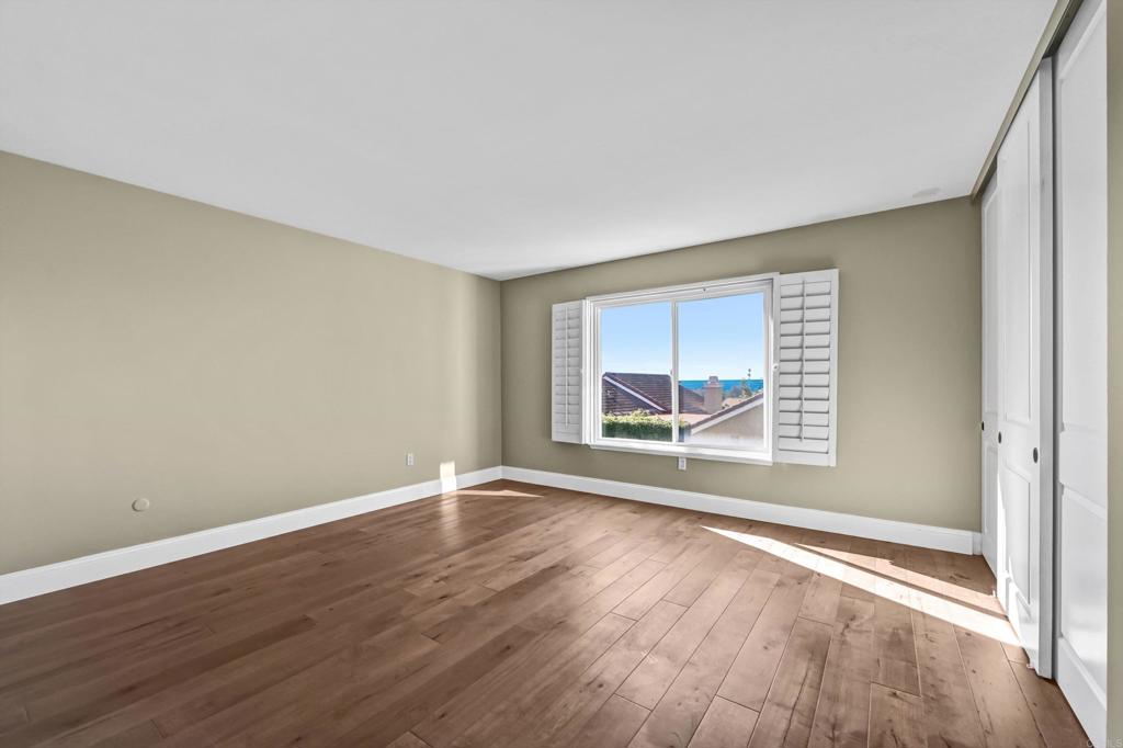1760 Gascony Road Encinitas, CA 92024 - Photo 30 of 49 an empty room with wooden floor and windows