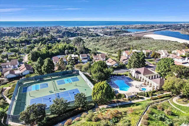 an aerial view of a tennis ground with a small pool