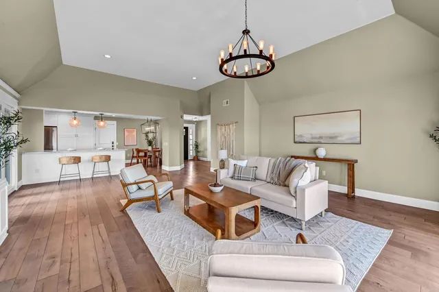 a living room with furniture a couch and a chandelier