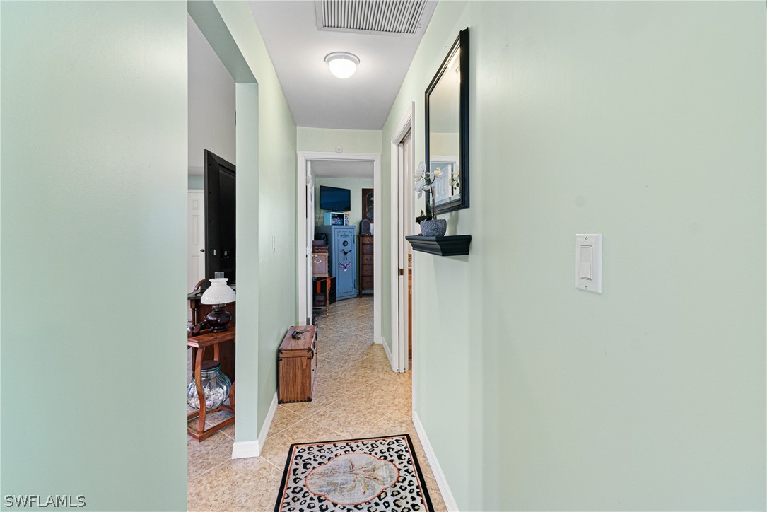 9701 Baycrest Terrace Lehigh Acres, FL 33936 - Photo 11 of 50 a view of hallway with stairs and wooden floor