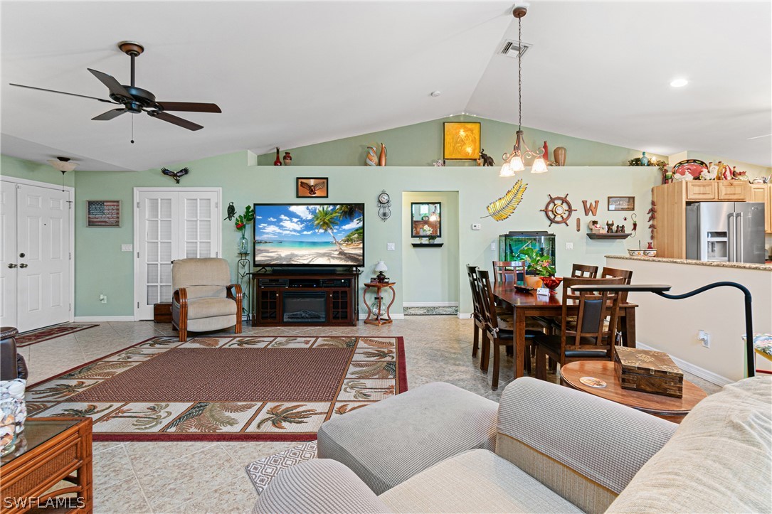 9701 Baycrest Terrace Lehigh Acres, FL 33936 - Photo 13 of 50 a living room with furniture and a fireplace