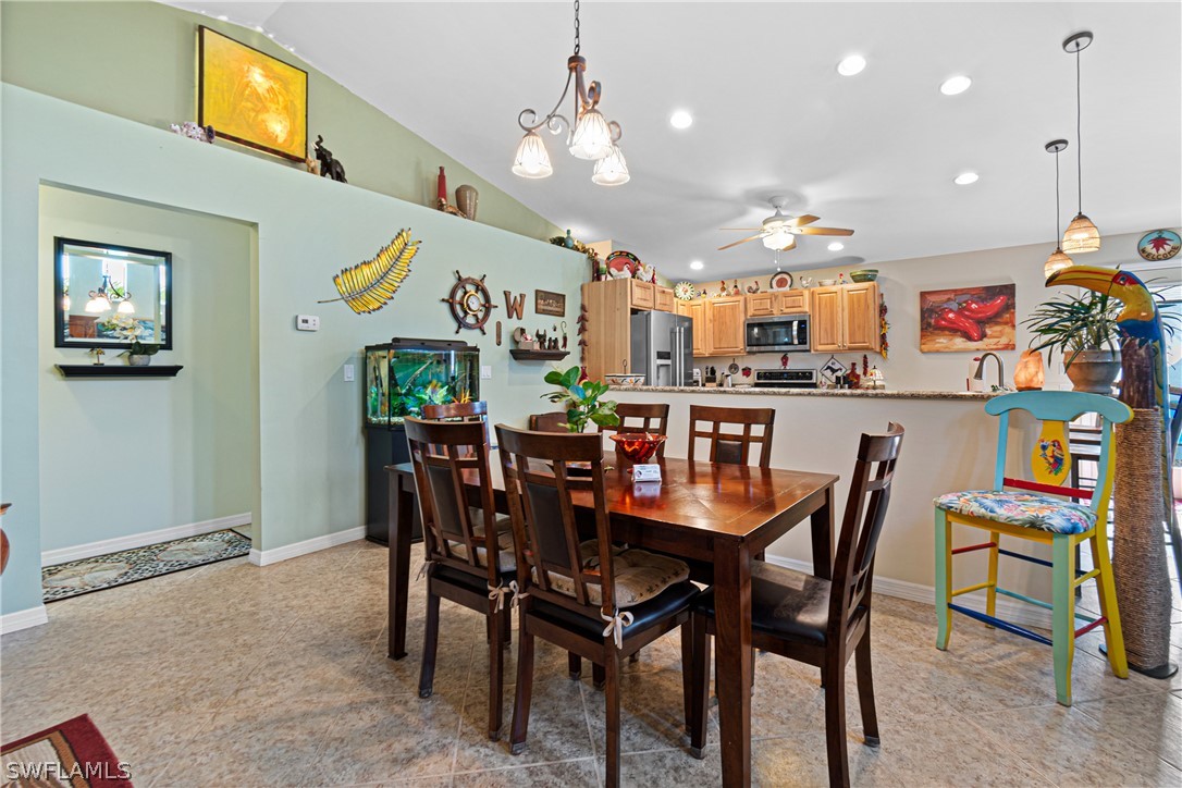 9701 Baycrest Terrace Lehigh Acres, FL 33936 - Photo 17 of 50 a view of a dining room with furniture and a chandelier
