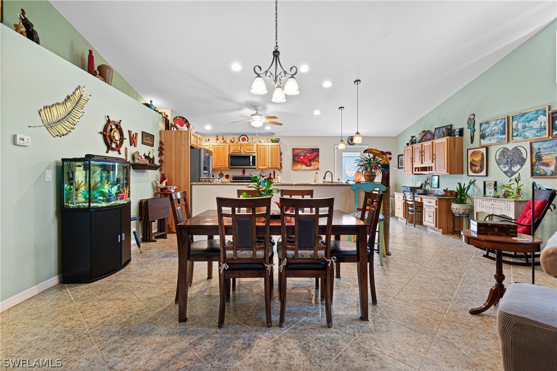 9701 Baycrest Terrace Lehigh Acres, FL 33936 - Photo 18 of 50 a view of a dining room with furniture and a chandelier