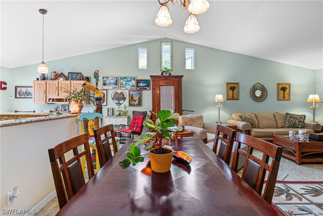 9701 Baycrest Terrace Lehigh Acres, FL 33936 - Photo 19 of 50 a living room with furniture and a chandelier