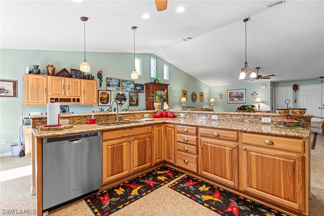 9701 Baycrest Terrace Lehigh Acres, FL 33936 - Photo 23 of 50 a kitchen with kitchen island granite countertop a sink and a stove