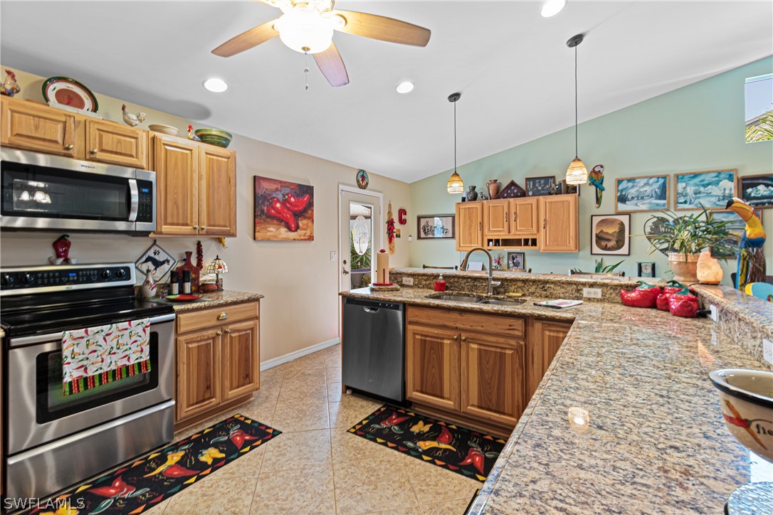 9701 Baycrest Terrace Lehigh Acres, FL 33936 - Photo 24 of 50 a kitchen with stainless steel appliances granite countertop a stove and a sink