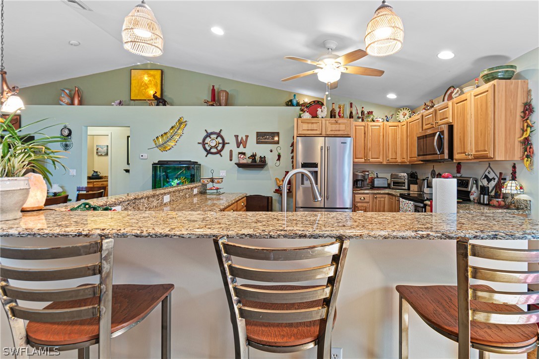 9701 Baycrest Terrace Lehigh Acres, FL 33936 - Photo 25 of 50 a kitchen with stainless steel appliances granite countertop a sink and cabinets