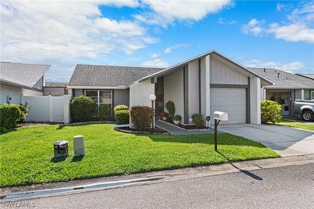 9701 Baycrest Terrace Lehigh Acres, FL 33936 - Photo 3 of 50 a front view of house with yard and green space