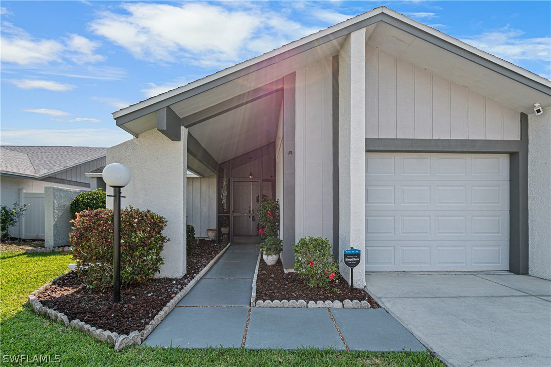 9701 Baycrest Terrace Lehigh Acres, FL 33936 - Photo 4 of 50 a front view of a house having yard