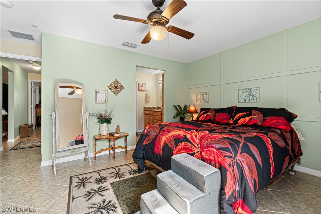 9701 Baycrest Terrace Lehigh Acres, FL 33936 - Photo 41 of 50 a bedroom with double bed and a chandelier