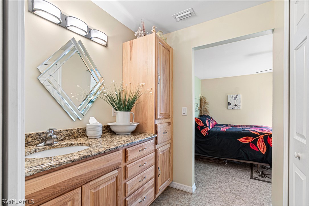 9701 Baycrest Terrace Lehigh Acres, FL 33936 - Photo 44 of 50 a living room with furniture and a potted plant