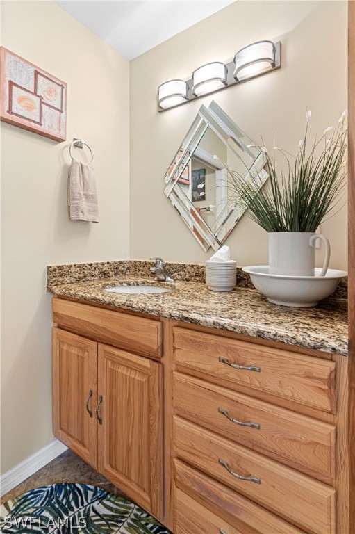 9701 Baycrest Terrace Lehigh Acres, FL 33936 - Photo 45 of 50 a bathroom with a granite countertop sink and a mirror