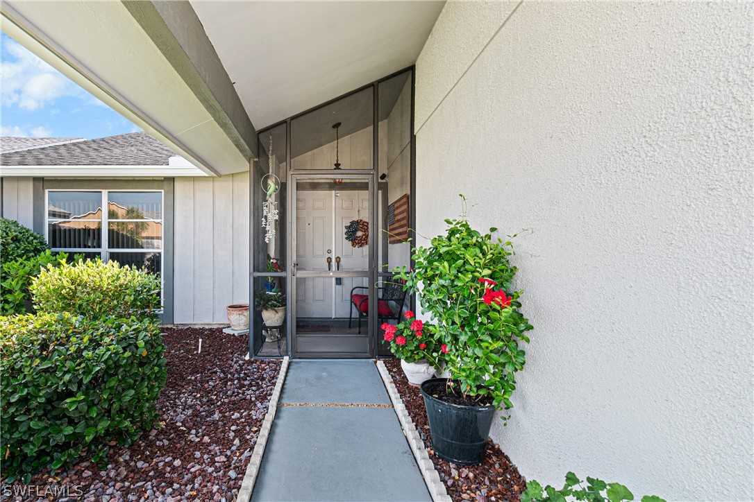 9701 Baycrest Terrace Lehigh Acres, FL 33936 - Photo 5 of 50 a hallway with flowers and flowers