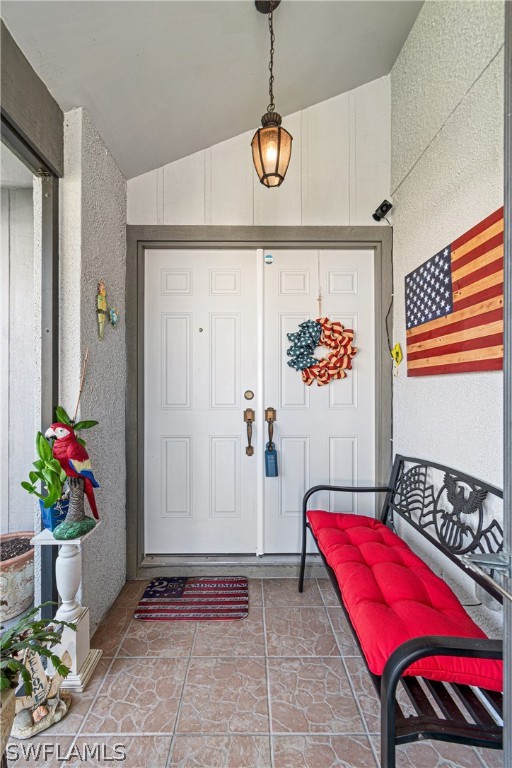 9701 Baycrest Terrace Lehigh Acres, FL 33936 - Photo 7 of 50 a bedroom with a bed and a chandelier