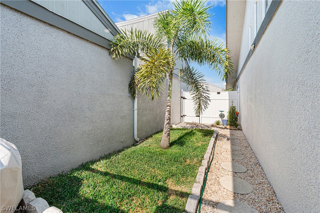 9701 Baycrest Terrace Lehigh Acres, FL 33936 - Photo 8 of 50 a view of a yard with plants